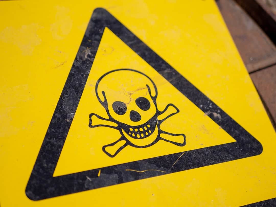 Yellow hazard warning sign with a black triangle and a skull-and-crossbones symbol indicating poison or danger.